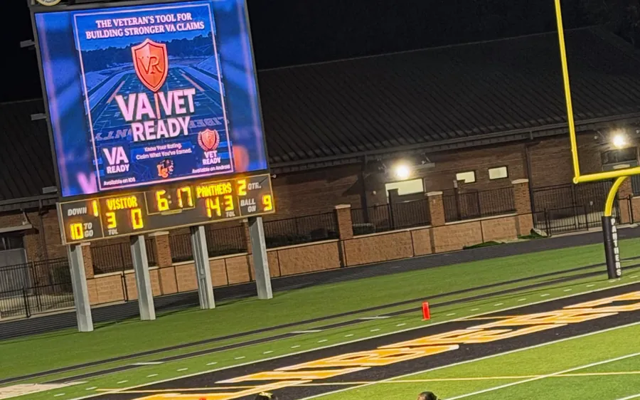 The VA Ready and Vet Ready board lit up on the jumbotron at Kirk Warner Field during the Liberty County Panthers homecoming game, with the scoreboard below showing the Panthers leading 14 to 3 in the second quarter